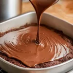 Delicious buttermilk chocolate cake slice on a plate with frosting