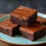 Delicious fudge iced brownies topped with a glossy chocolate icing