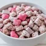 Valentine’s Day themed Muddy Buddies in heart shapes and festive colors.